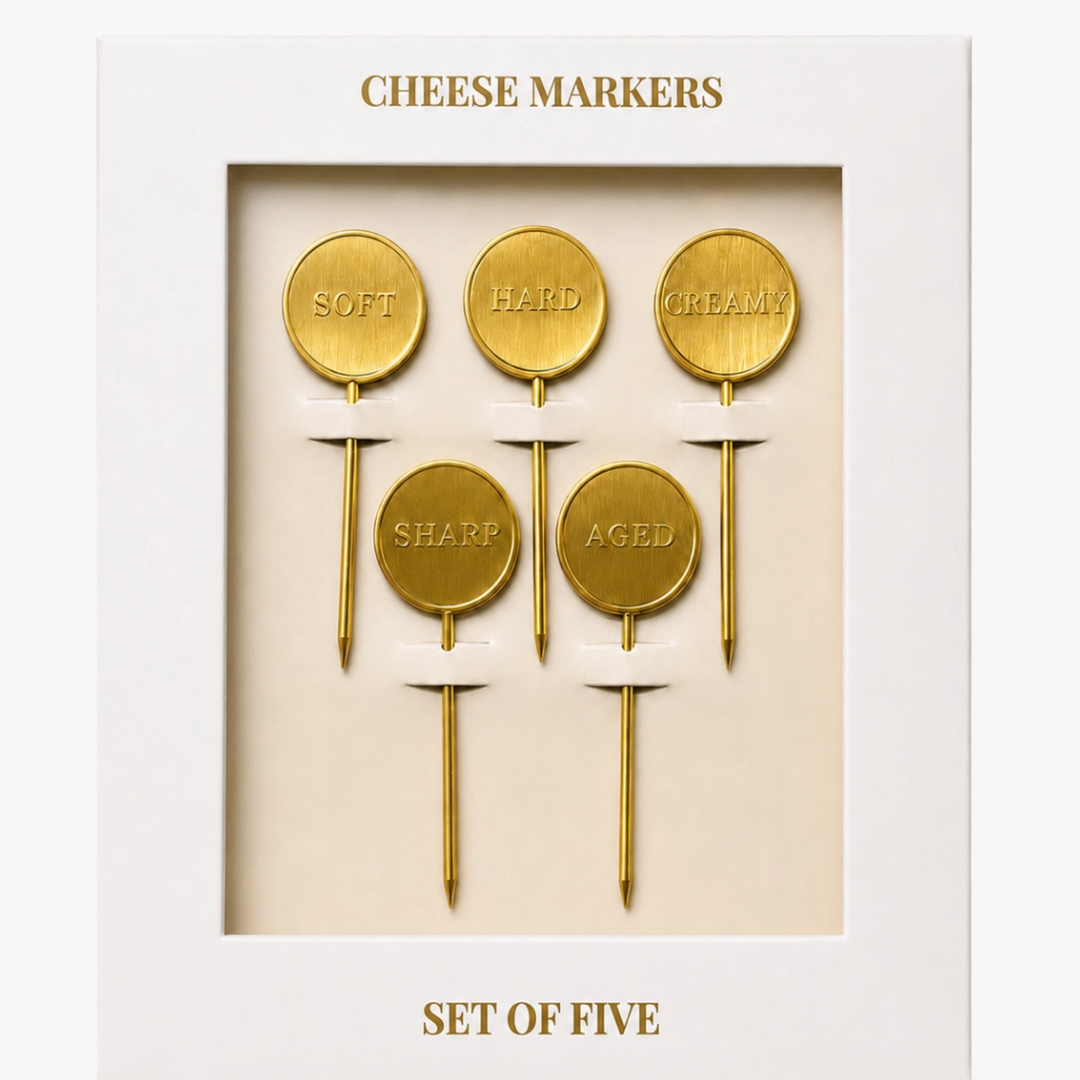 A boxed set of five gold cheese markers with round signs reading SOFT, HARD, CREAMY, SHARP, and AGED, presented in a white package with gold text.