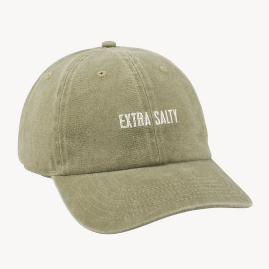 An olive green washed cotton baseball cap with 'EXTRA SALTY' embroidered in white on the front, shown against a plain off-white background.